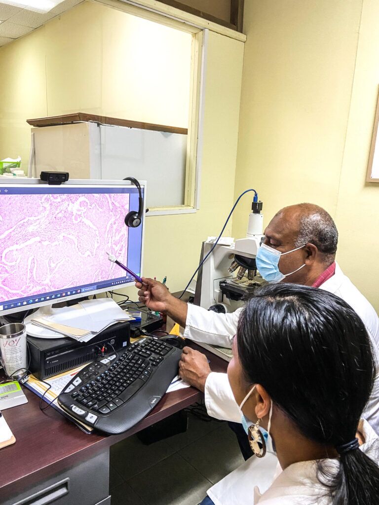 Pohnpei Histopath technician Mr. Saimone Vameau viewing slide through the screen.